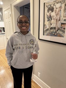 Nadiyah holding forensics trophy